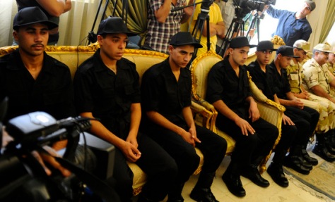 Soldiers who were kidnapped last week sit before a news conference by President Mohamed Mursi after their release