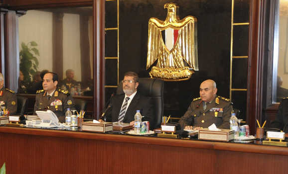 Egyptian President Mohamed Mursi sits next to the head of the Egyptian military General Abdel Fattah al-Sisi and top military and police chiefs during their meeting in Cairo